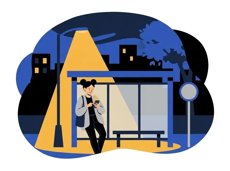 Yuki standing at a bus stop at night under a street lamp, looking at her phone