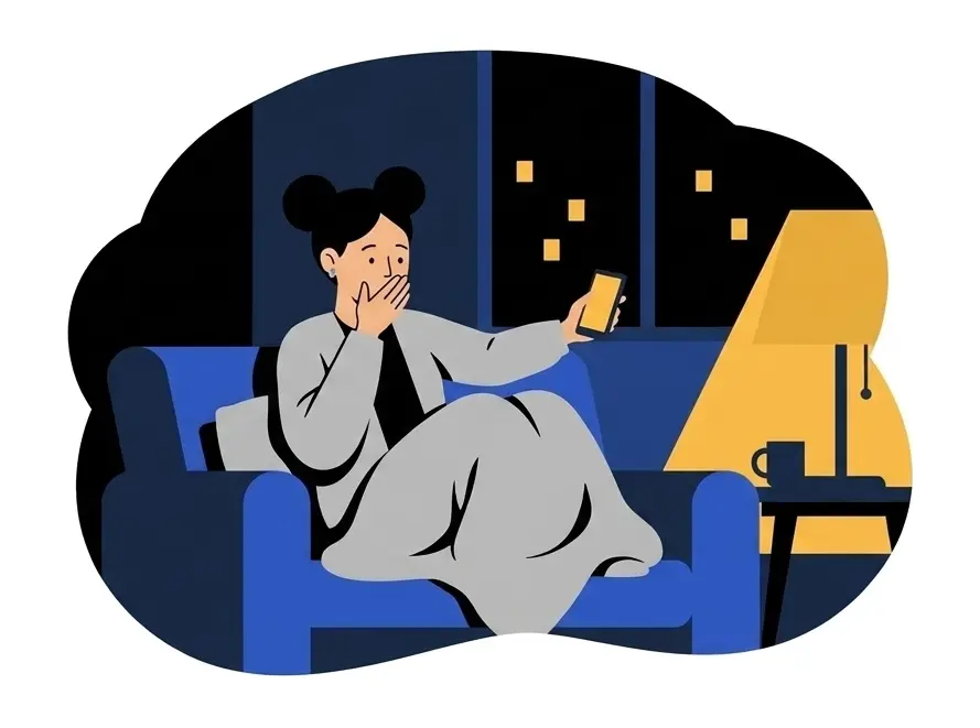 Yuki on a sofa under a blanket with one hand over her mouth, holding her phone out in the other